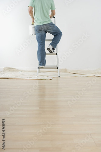 Photo: Hispanic man climbing ladder Hispanic man climbing ladder