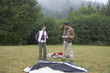Indian couple putting up tent