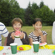 Mixed Race brother and sister eating watermelon