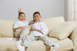 Indian brothers being silly on sofa