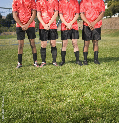 Photo: Multi-ethnic male soccer players in park Multi-ethnic male soccer players in park
