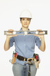 Hispanic female construction worker holding level
