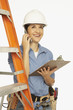 Hispanic female construction worker talking on cell phone