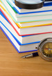 pile of books and pen on wood pile of books and pen on wood