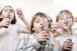 children blowing bubbles