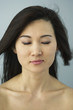 Asian woman with eyes closed