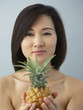 Asian woman holding pineapple