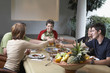 Family toasting at dinner table