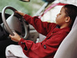 African boy pretending to drive car