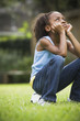 African girl sitting on soccer ball