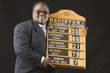 African man holding hymn board