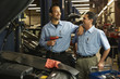 Multi-ethnic male auto mechanics in shop