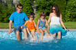 Family summer vacation, having fun near swimming pool