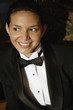 Hispanic female waiter in tuxedo