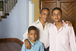 Hispanic father and sons hugging