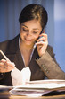 Hispanic businesswoman eating take out food