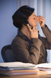 Hispanic businesswoman talking on telephone