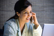 Hispanic businesswoman working in pajamas