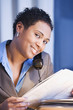 African businesswoman reading newspaper