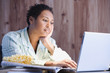 African businesswoman working in pajamas