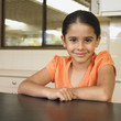Burmese girl leaning on kitchen counter