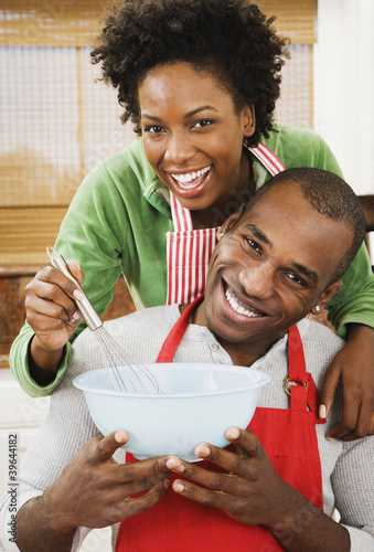 Photo: African American couple baking in kitchen African American couple baking in kitchen
