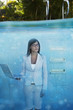 South American businesswoman in swimming pool