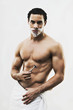 Mixed Race man in towel shaving