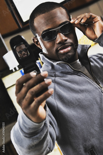 Photo: African man shopping for sunglasses African man shopping for sunglasses