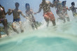 South American couples running in water