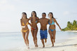 South American friends running at beach