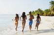 South American friends running at beach