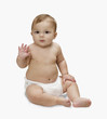 Studio shot of baby waving