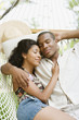 African American couple sleeping in hammock