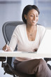 African American businesswoman looking at laptop
