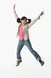Chinese woman jumping with arms raised