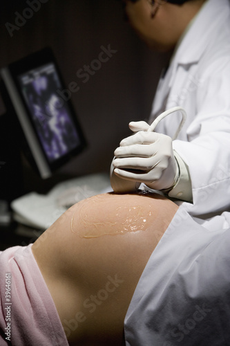 Photo: Pregnant Hispanic woman getting ultrasound Pregnant Hispanic woman getting ultrasound