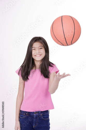 Photo: Ten year old Asian girl throwing basketball Ten year old Asian girl throwing basketball