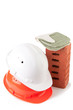 Two hard-hats, house brick and mittens, isolated on white