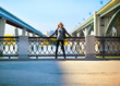 Beautiful woman with bridge on the background
