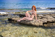 Greece. Rhodes. The young beautiful woman on seacoast