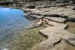 Greece.Rhodes.The young beautiful woman on seacoast...