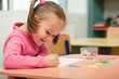 Photo: Little girl is playing with plasticine Little girl is playing with plasticine