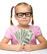 Photo: Cute cheerful little girl with paper money Cute cheerful little girl with paper money