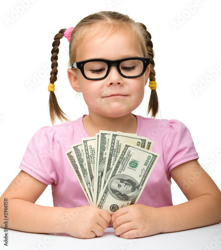 Photo: Cute cheerful little girl with paper money Cute cheerful little girl with paper money