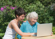 Grandmother and granddaughter with laptop