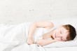 Boy sleeping 4 years brick wall