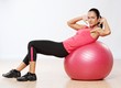 Beautiful athlete woman with a fitness ball.