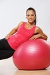 Beautiful athlete woman with a fitness ball.
