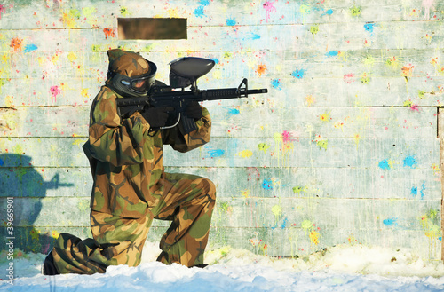 Photo: paintball player with marker at winter outdoors paintball player with marker at winter outdoors